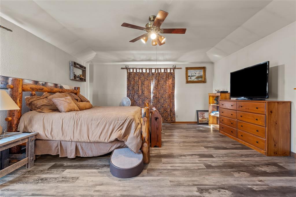 262 North Cheyenne Springtown, TX 76082 - Photo 22 of 35 Bedroom with wood finished floors, ceiling fan, and lofted ceiling