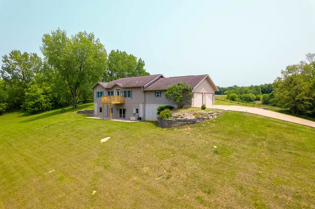 a front view of house with yard and lake view