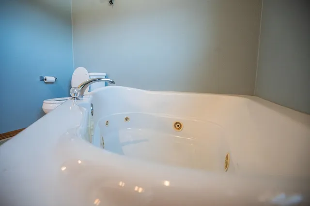 a bathroom with a toilet sink and mirror