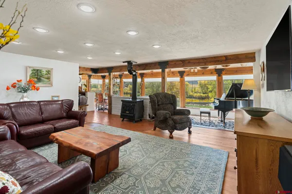 a living room with furniture and a floor to ceiling window