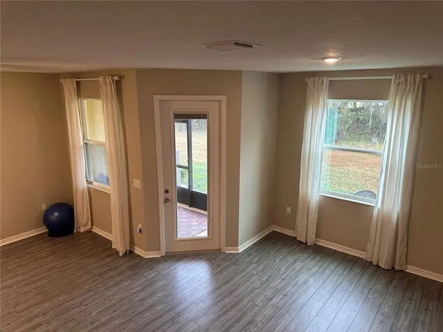 a view of room with window and wooden floor
