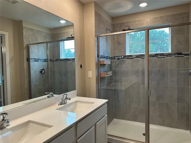 a bathroom with a sink and mirror