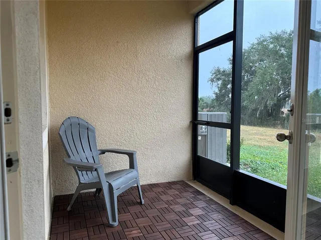 a view of a balcony with chair and table