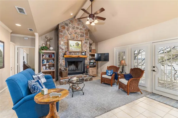 a living room with furniture a fireplace and a flat screen tv