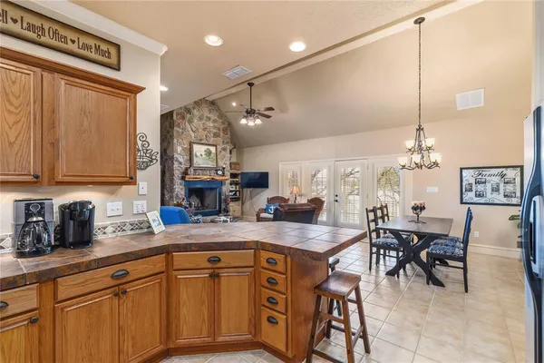 a kitchen with stainless steel appliances granite countertop a sink refrigerator and cabinets