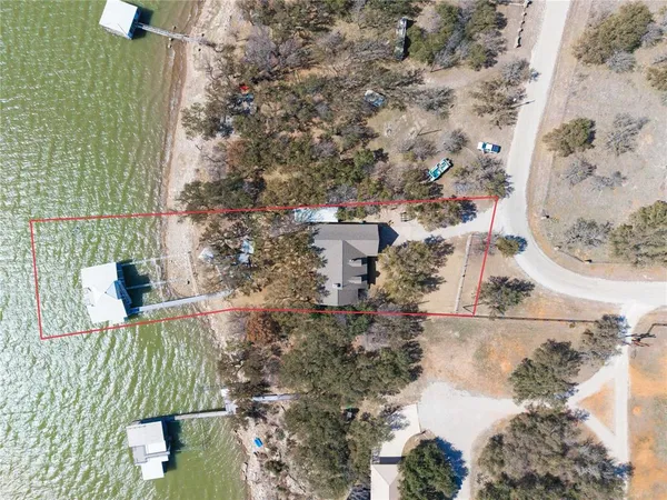 a front view of a house with a yard and potted plants