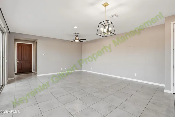 a front view of a house with a yard and potted plants