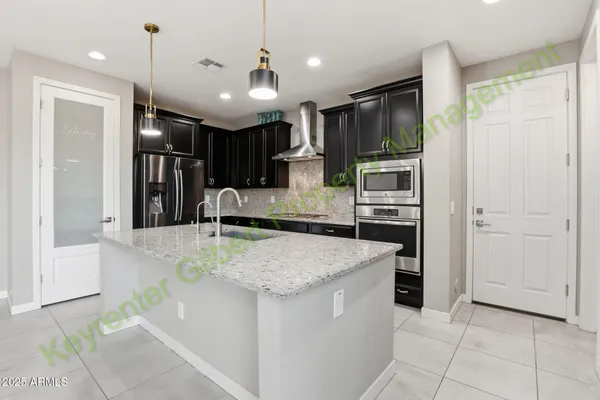 a view of a kitchen with a sink and a refrigerator