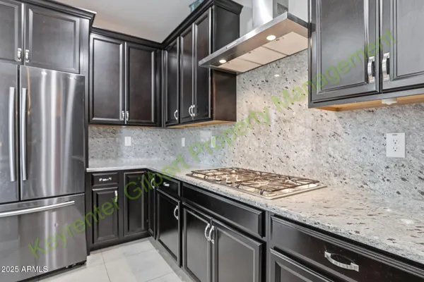 a view of kitchen with furniture and refrigerator
