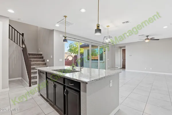 an empty room with kitchen view