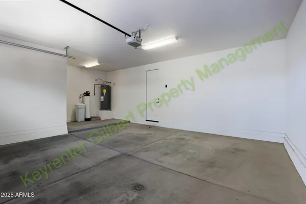a view of an empty room with a window and a flat screen tv