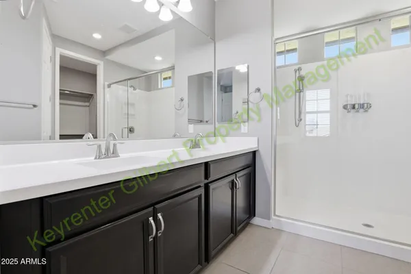 an empty room with closet and a chandelier fan