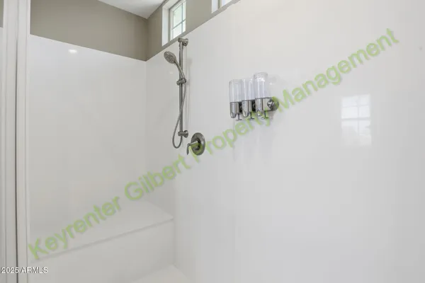 an empty room with closet and fan