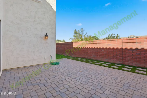 a bathroom with a granite countertop sink a mirror and a shower