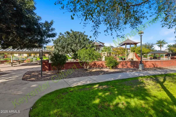 a view of green field with house in background