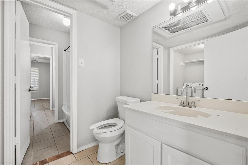 5821 Mansfield Road Arlington, TX 76017 - Photo 15 of 24 a bathroom with a sink toilet and shower