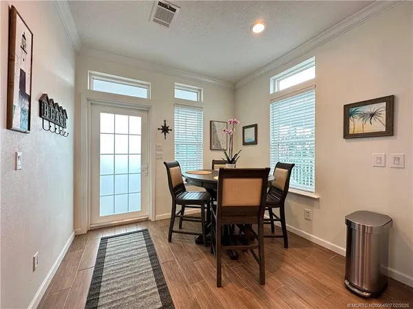 a view of a dining room with furniture and wooden floor
