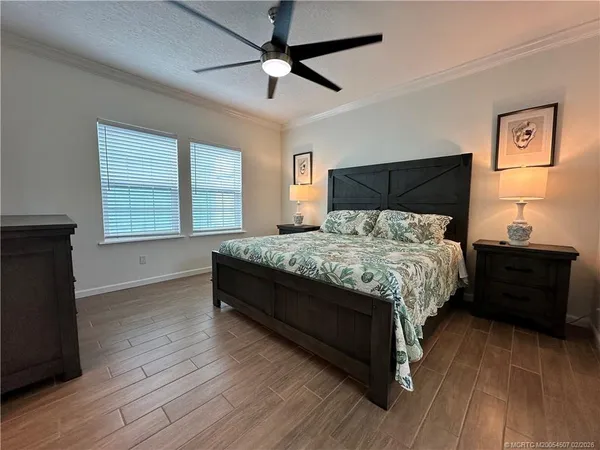 a bedroom with a bed and wooden floor
