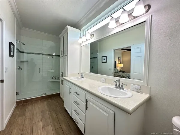 a bathroom with a double vanity sink and mirror