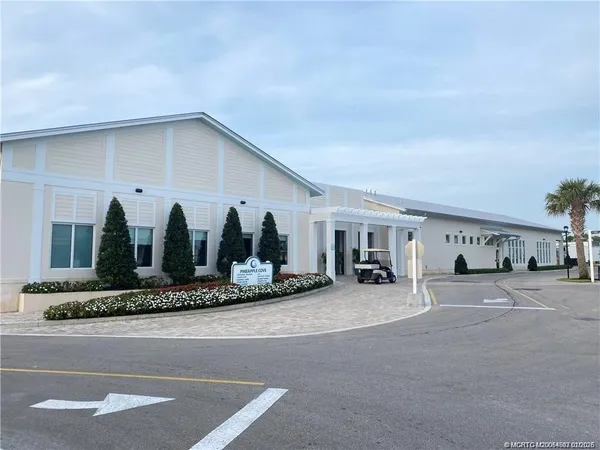 a view of a house with backyard and plants