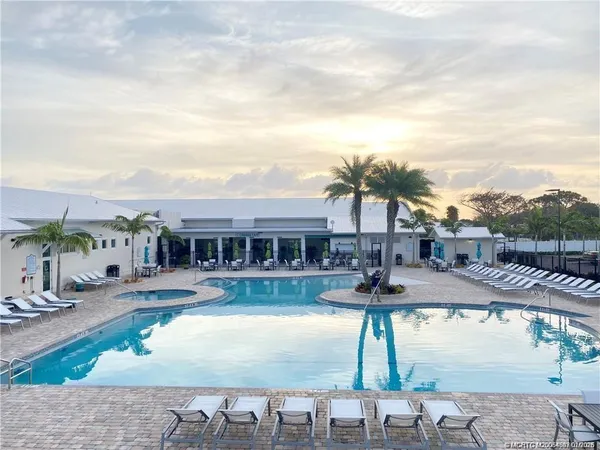 a view of a patio with dining table and chairs with wooden floor