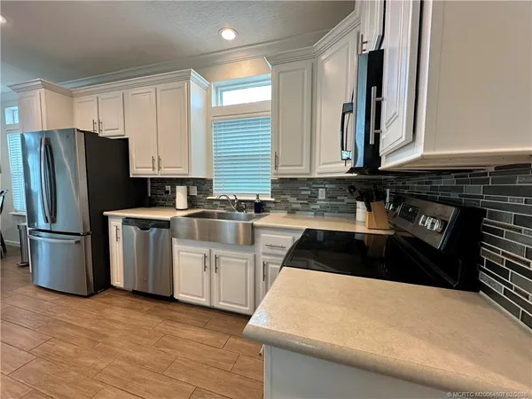 a kitchen with a sink a stove and refrigerator