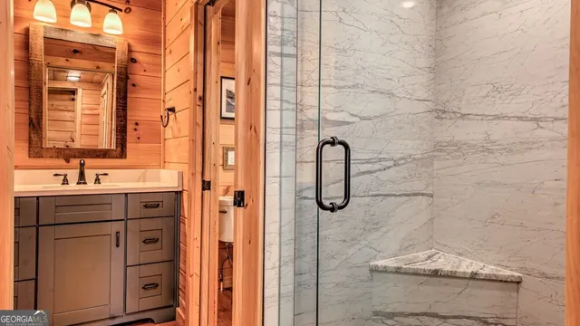 a bathroom with a shower sink and mirror