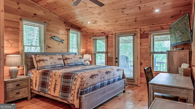 a bedroom with a bed next to a large window with the outer view