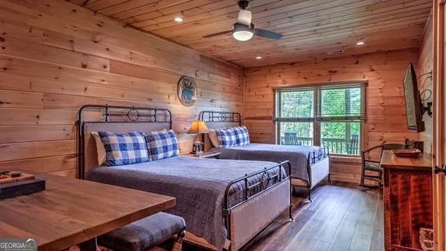 a bedroom with a bed next to a large window