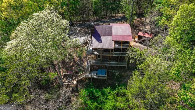 an aerial view of a house with a yard and trees