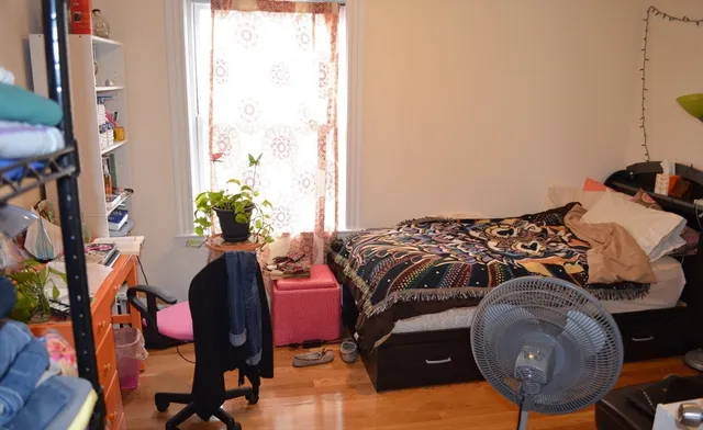 a bed room with a bed and a chair