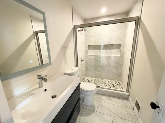 a bathroom with a bathtub and a shower