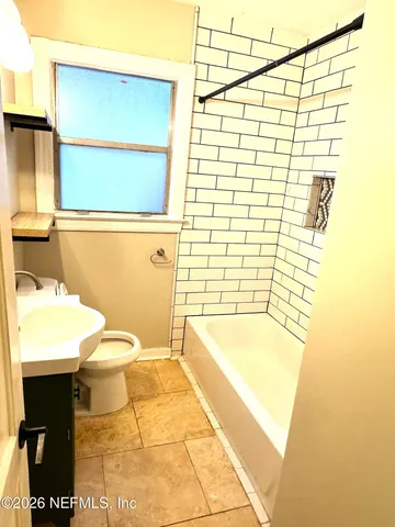 a bathroom with a bathtub and a toilet