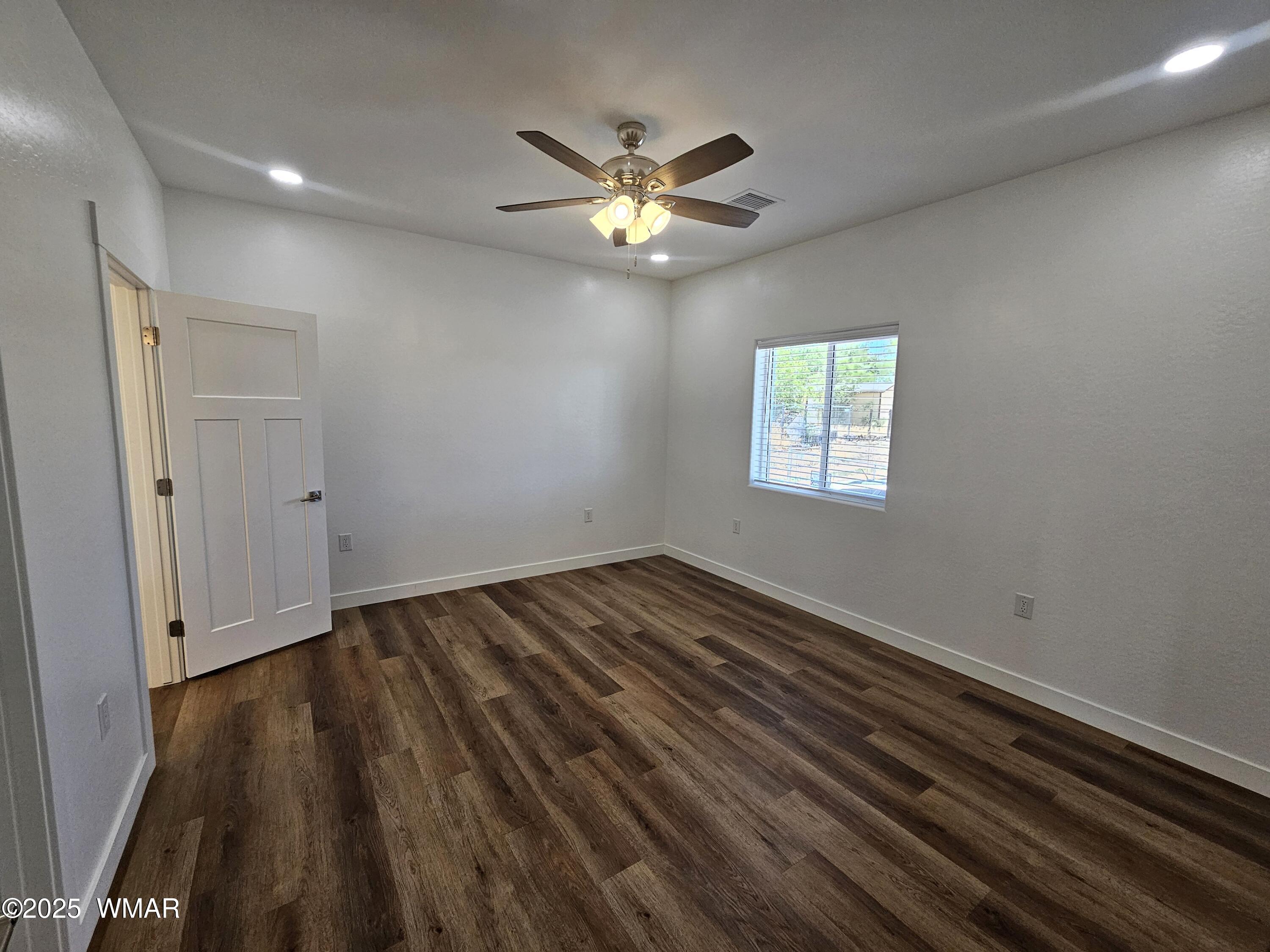 759 South 5th W Street Snowflake, AZ 85937 - Photo 13 of 18 a view of an empty room with wooden floor and a window