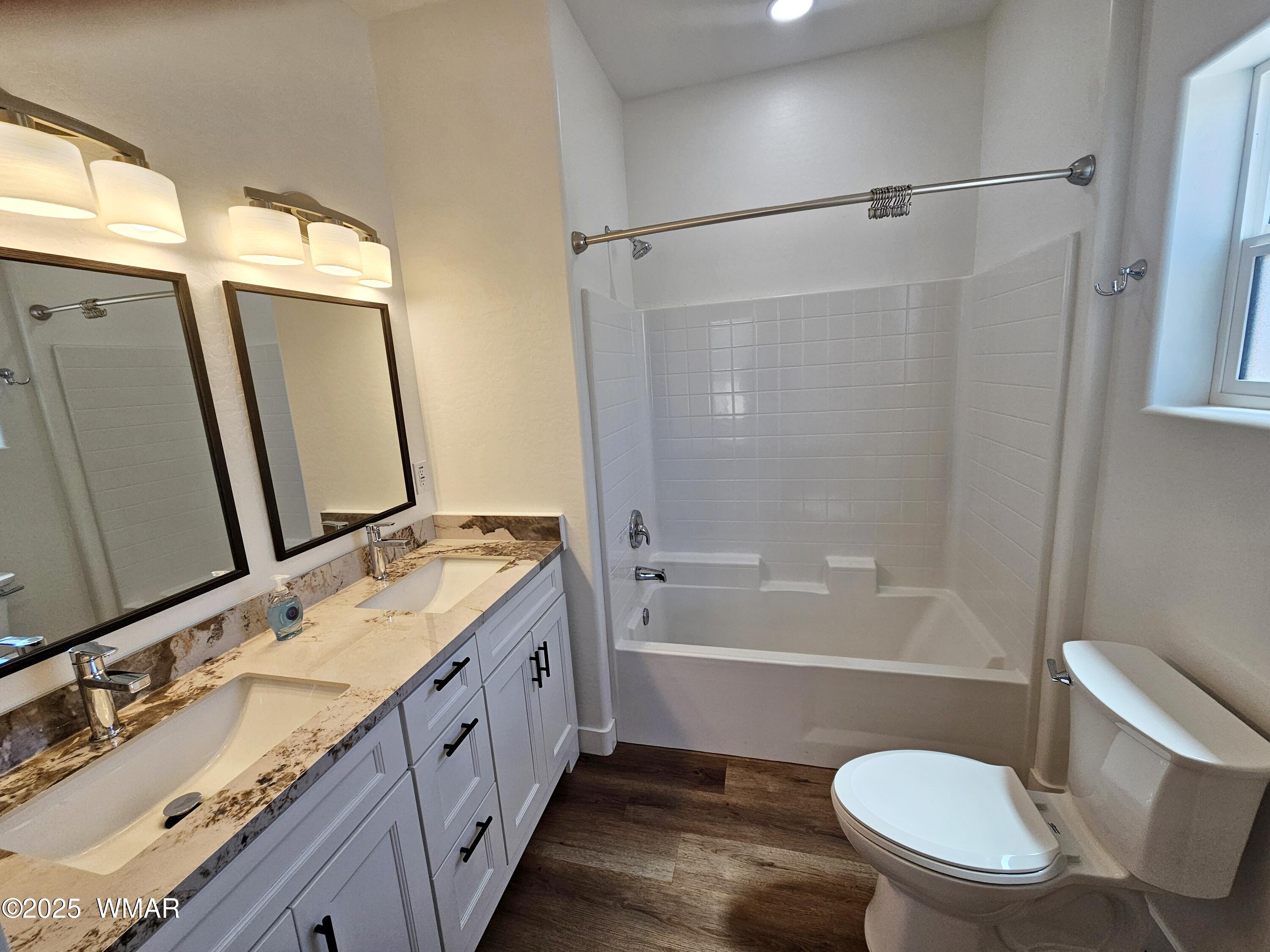 759 South 5th W Street Snowflake, AZ 85937 - Photo 15 of 18 a bathroom with a double vanity sink toilet mirror and shower