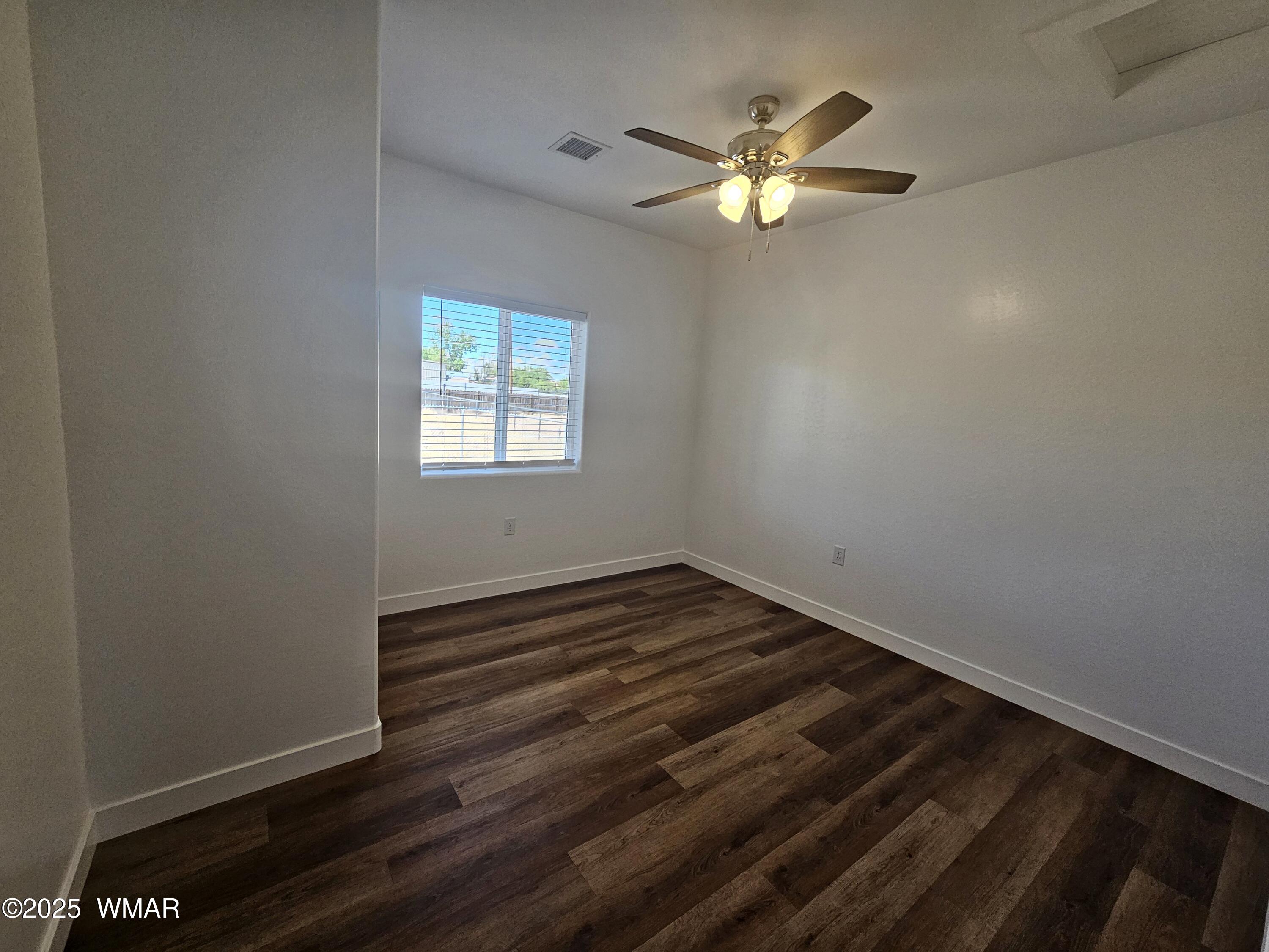 759 South 5th W Street Snowflake, AZ 85937 - Photo 17 of 18 a view of an empty room with wooden floor and a window