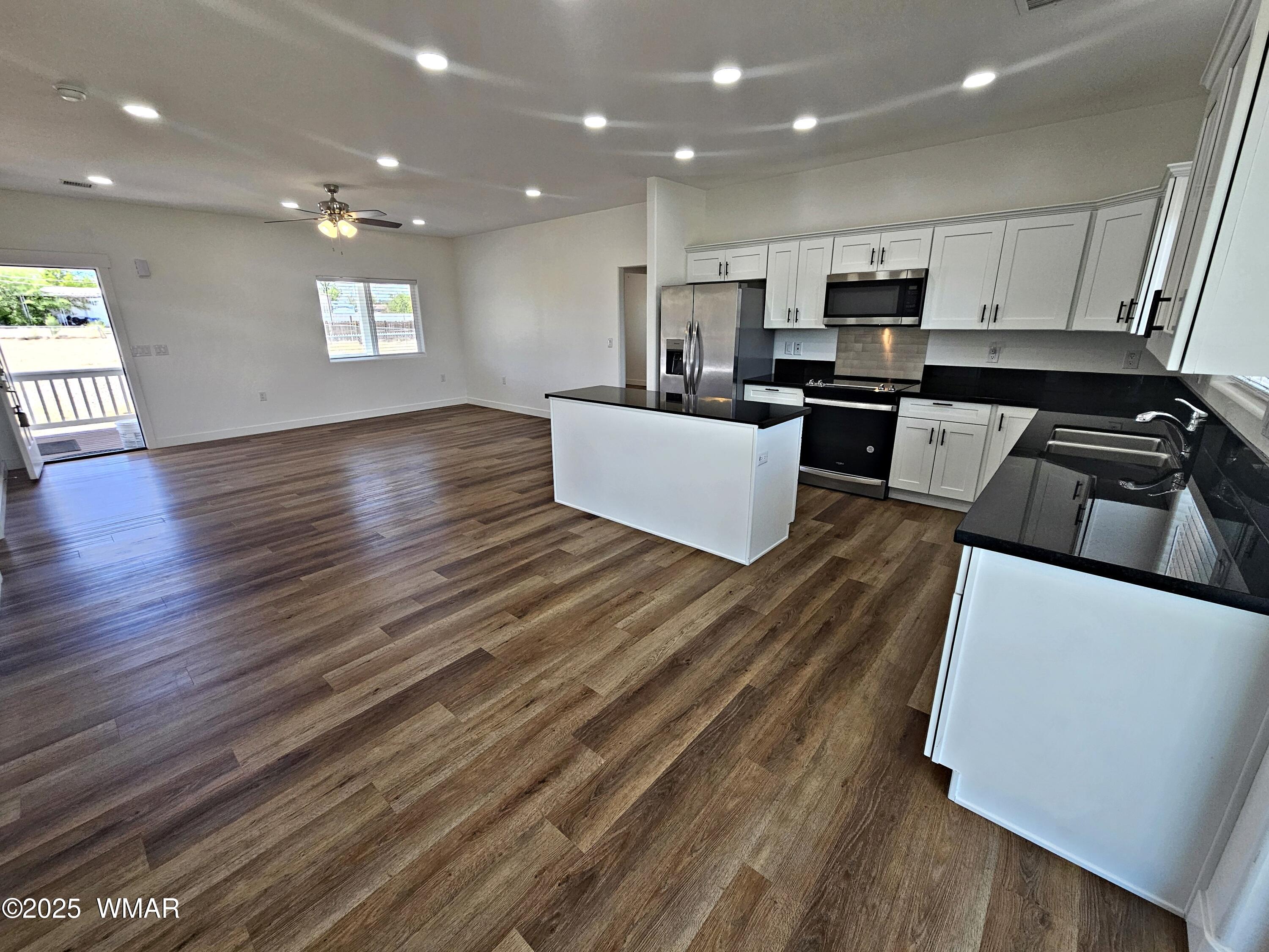 759 South 5th W Street Snowflake, AZ 85937 - Photo 10 of 18 a kitchen with stainless steel appliances a refrigerator sink and cabinets