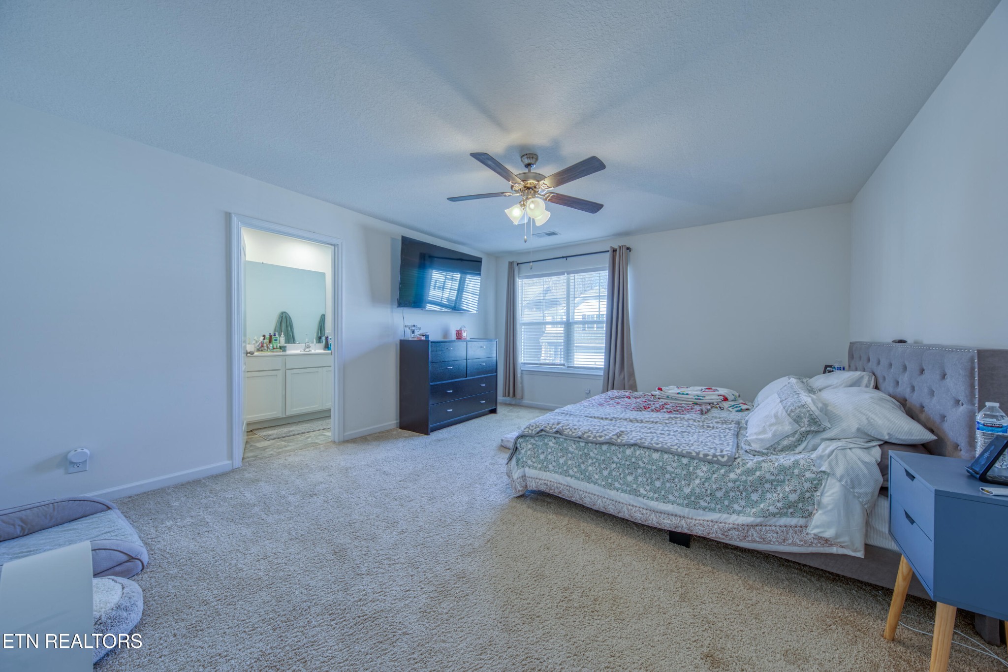 155 Ibis Loop Oak Ridge, TN 37830 - Photo 12 of 20 a spacious bedroom with a bed and a chandelier fan