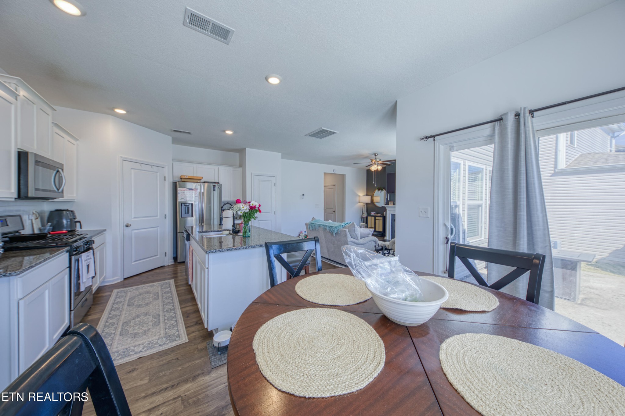155 Ibis Loop Oak Ridge, TN 37830 - Photo 8 of 20 a view of a dining room with furniture a rug and wooden floor