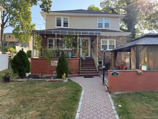 a view of a house with backyard porch and sitting area