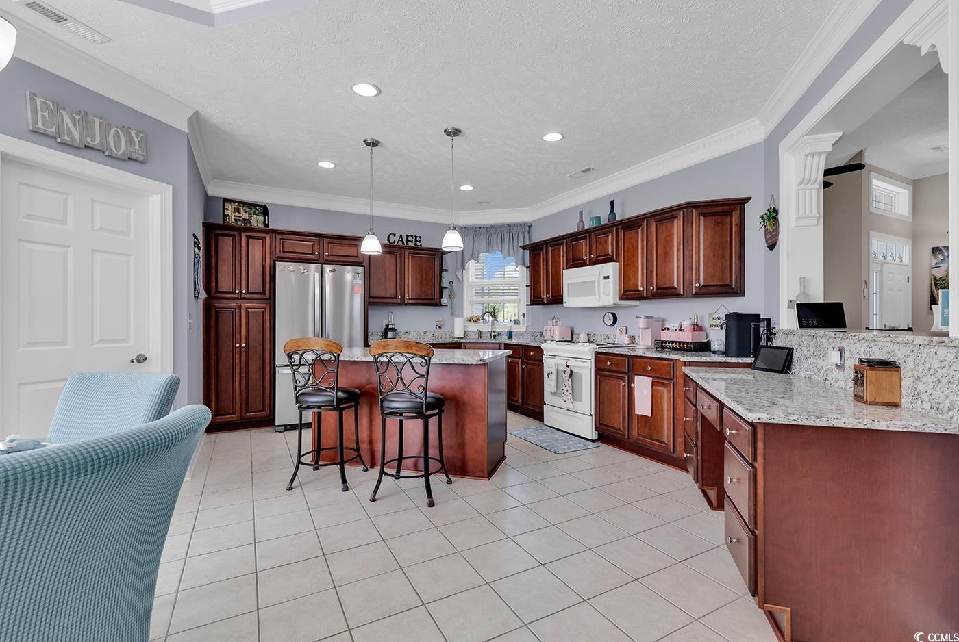 517 Stone Crest Court Murrells Inlet, SC 29576 - Photo 17 of 39 Kitchen with light stone counters, a textured ceil