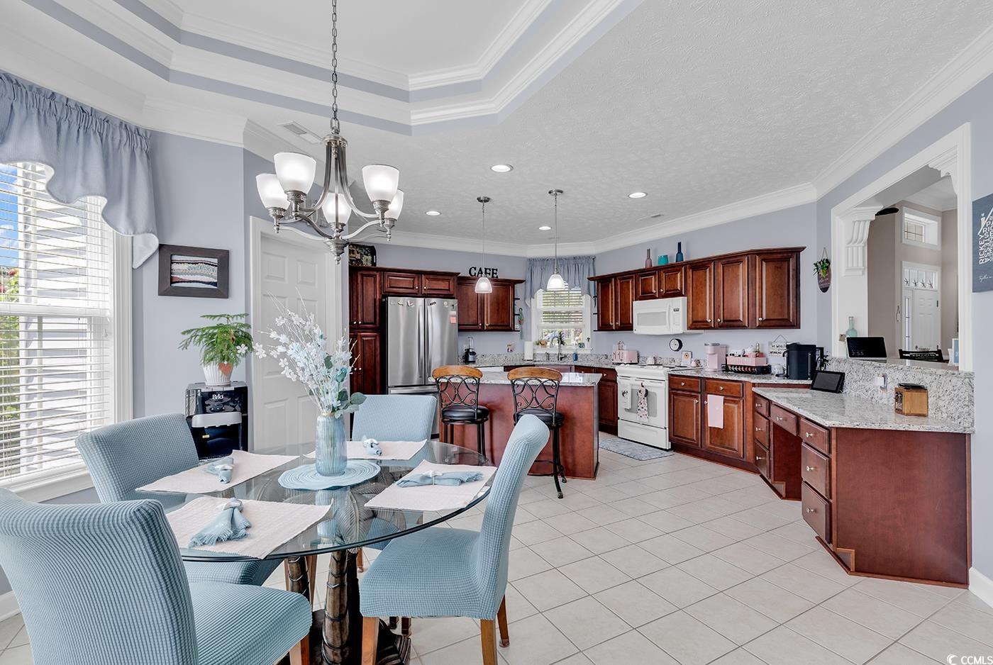 517 Stone Crest Court Murrells Inlet, SC 29576 - Photo 18 of 39 Dining area featuring crown molding, sink, light t