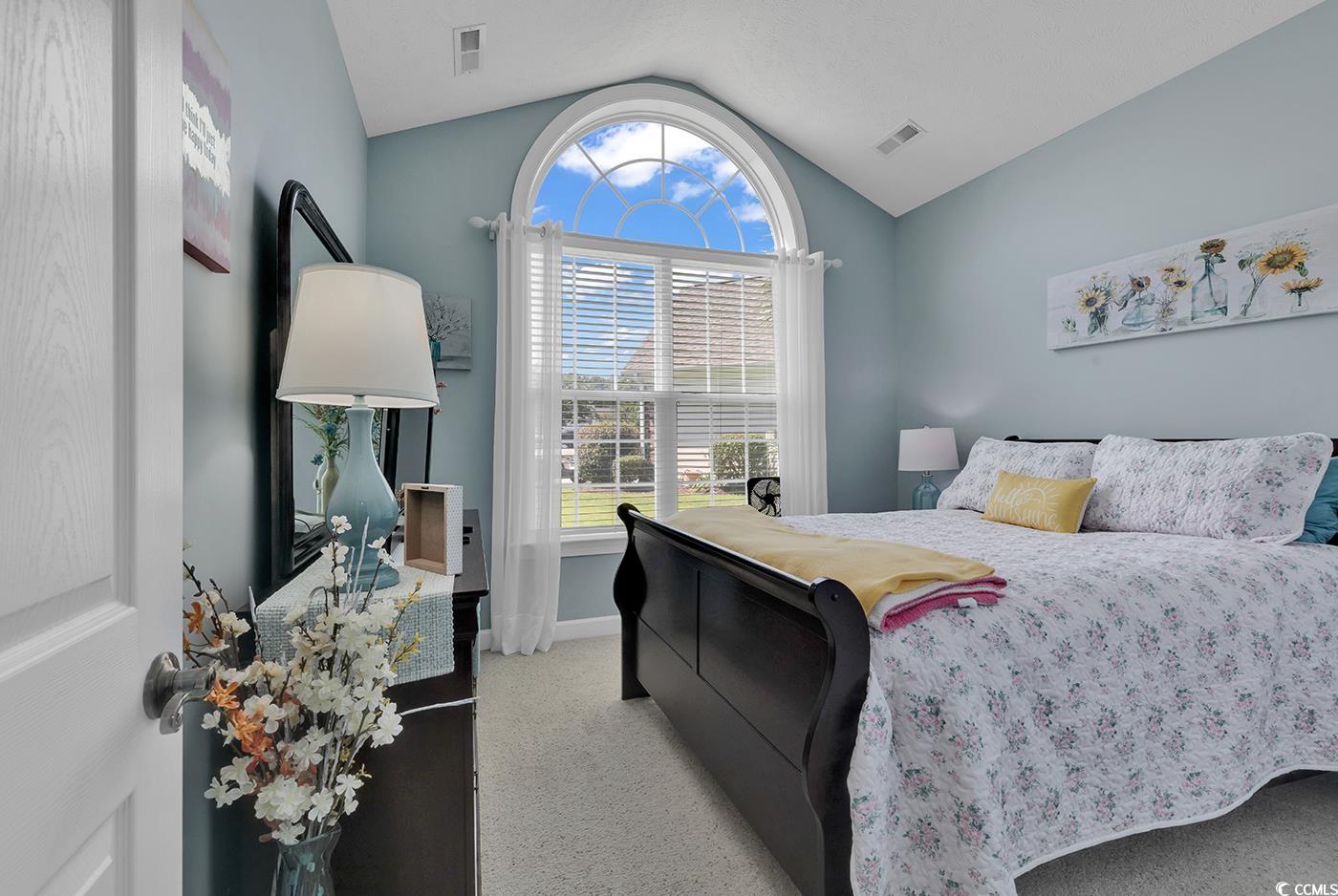 517 Stone Crest Court Murrells Inlet, SC 29576 - Photo 26 of 39 Bedroom with light colored carpet and vaulted ceil