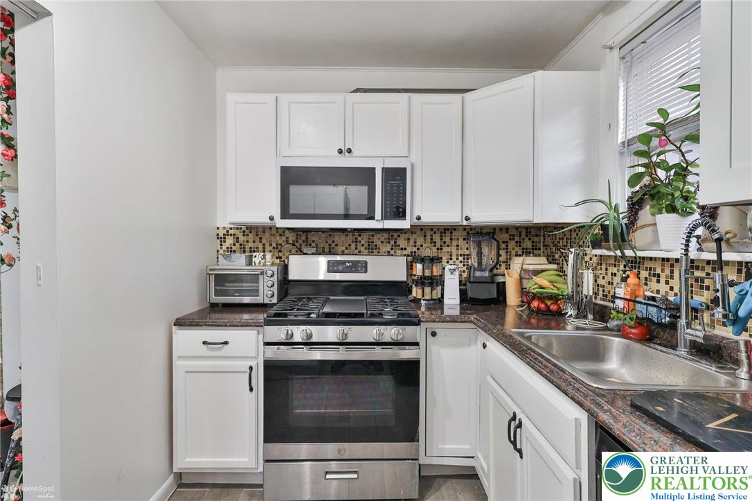 1147 Arcadia Street Bethlehem, PA 18018 - Photo 21 of 66 a kitchen with stainless steel appliances granite countertop a sink stove and microwave