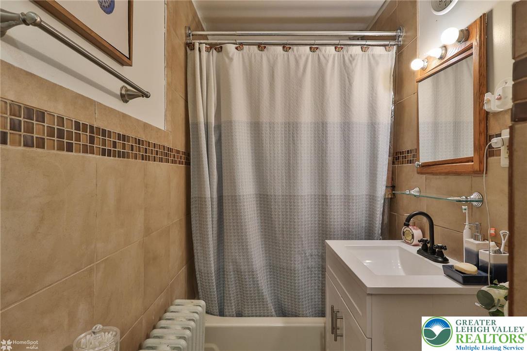 1147 Arcadia Street Bethlehem, PA 18018 - Photo 24 of 66 a bathroom with a sink and a mirror