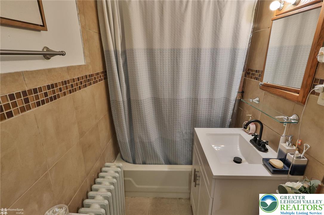 1147 Arcadia Street Bethlehem, PA 18018 - Photo 25 of 66 a bathroom with a sink and a mirror