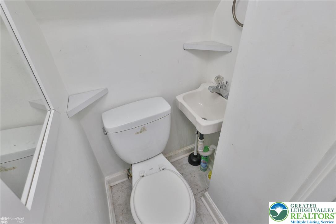 1147 Arcadia Street Bethlehem, PA 18018 - Photo 37 of 66 a white toilet sitting next to a white sink