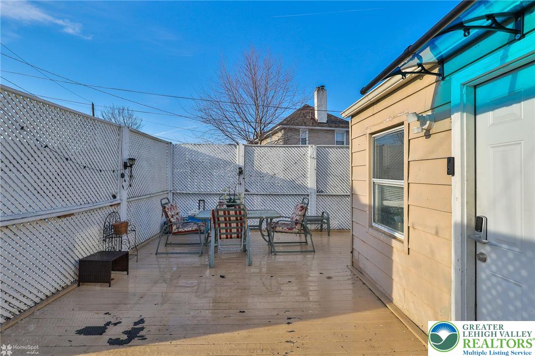 1147 Arcadia Street Bethlehem, PA 18018 - Photo 52 of 66 a view of a patio with table and chairs with wooden floor and fence