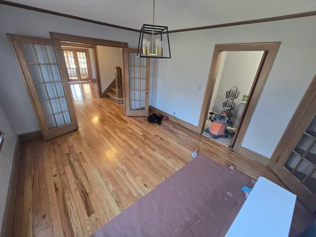 a view of a room with wooden floor and staircase