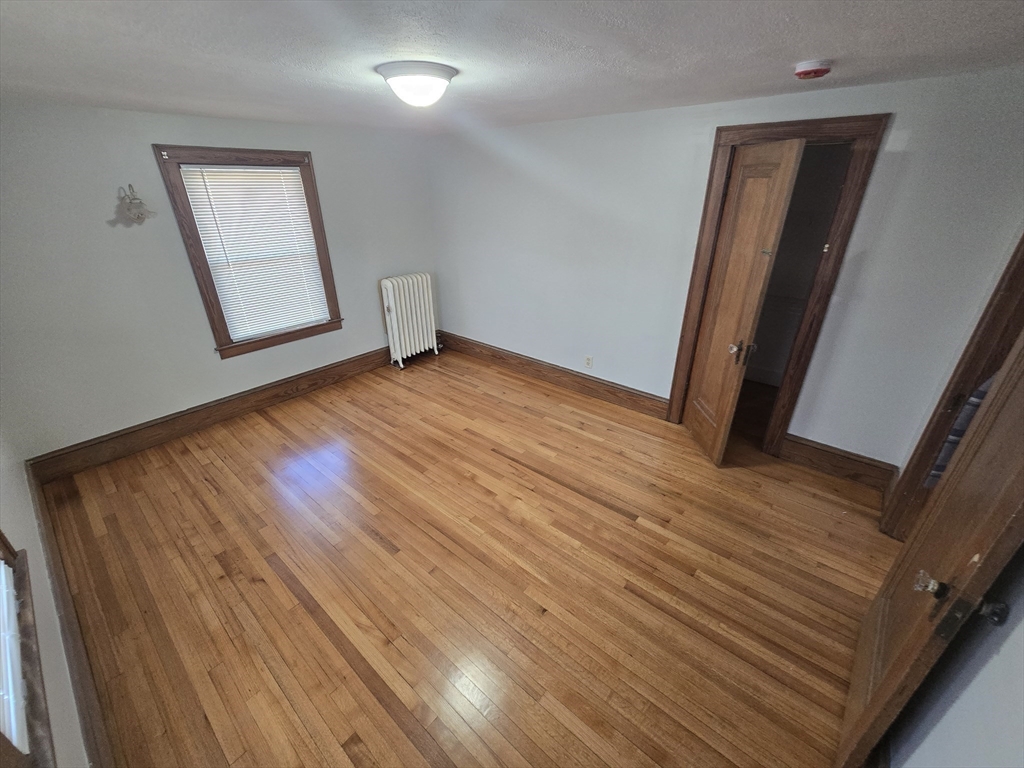 40 Catalpa Terrace Springfield, MA 01119 - Photo 20 of 24 a view of an empty room with wooden floor and a window